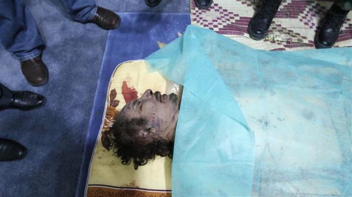 The body of former Libyan leader Muammar Gaddafi is displayed at a house in Misrata