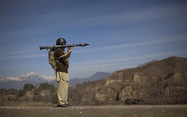 Pakistani soldier Hamed holds a rocket launcher while securing a road in Khar, the main town in Bajaur Agency, located in Pakistan's Federally Administered Tribal Areas (FATA) along the Afghanistan border, March 2, 2010.