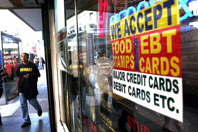 NEW YORK - OCTOBER 07: A sign in a market window advertises the acceptance of food stamps on October 7, 2010 in New York City. New York Mayor Michael Bloomberg is proposing an initiative that would prohibit New York City's 1.7 million food stamp recipients from using the stamps, a subsidy for poor residents, to buy soda or other sugary drinks. Bloomberg has stressed that obesity among the poor has reached critical levels.   Spencer Platt/Getty Images/AFP
