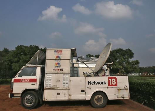A van of media group Network18 is parked outside the Indian parliament in New Delhi