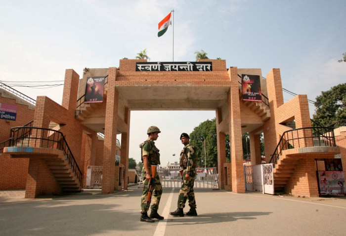India's Border Security Force (BSF) soldiers patrol in front of the golden jubilee gate at the Wagah border, on the outskirts of the northern Indian city of Amritsar, November 3, 2014. India and Pakistan have suspended a daily military ritual on their main land border crossing after a suicide attack that killed dozens of people, the first time the colorful parade has been called off since the two countries went to war in 1971. India's home ministry said BSF agreed to a Pakistani request to suspend the flag-lowering ceremony to allow mourning. At least 45 people were killed and more than 100 wounded on Sunday by the explosion that ripped through a carpark about 500 meters (yards) from Pakistan's border gate just as hundreds of people left the popular daily performance. REUTERS/Munish Sharma (INDIA - Tags: POLITICS CIVIL UNREST MILITARY TPX IMAGES OF THE DAY) - RTR4CLI5