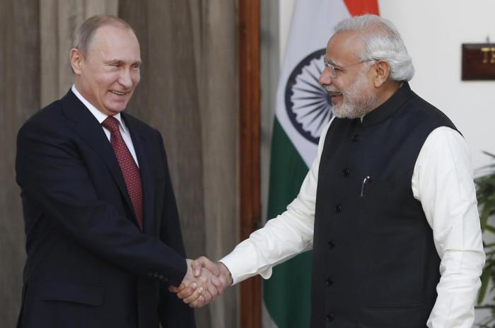 Russian President Putin shakes hands with India's Prime Minister Modi during a photo opportunity ahead of their meeting at Hyderabad House in New Delhi